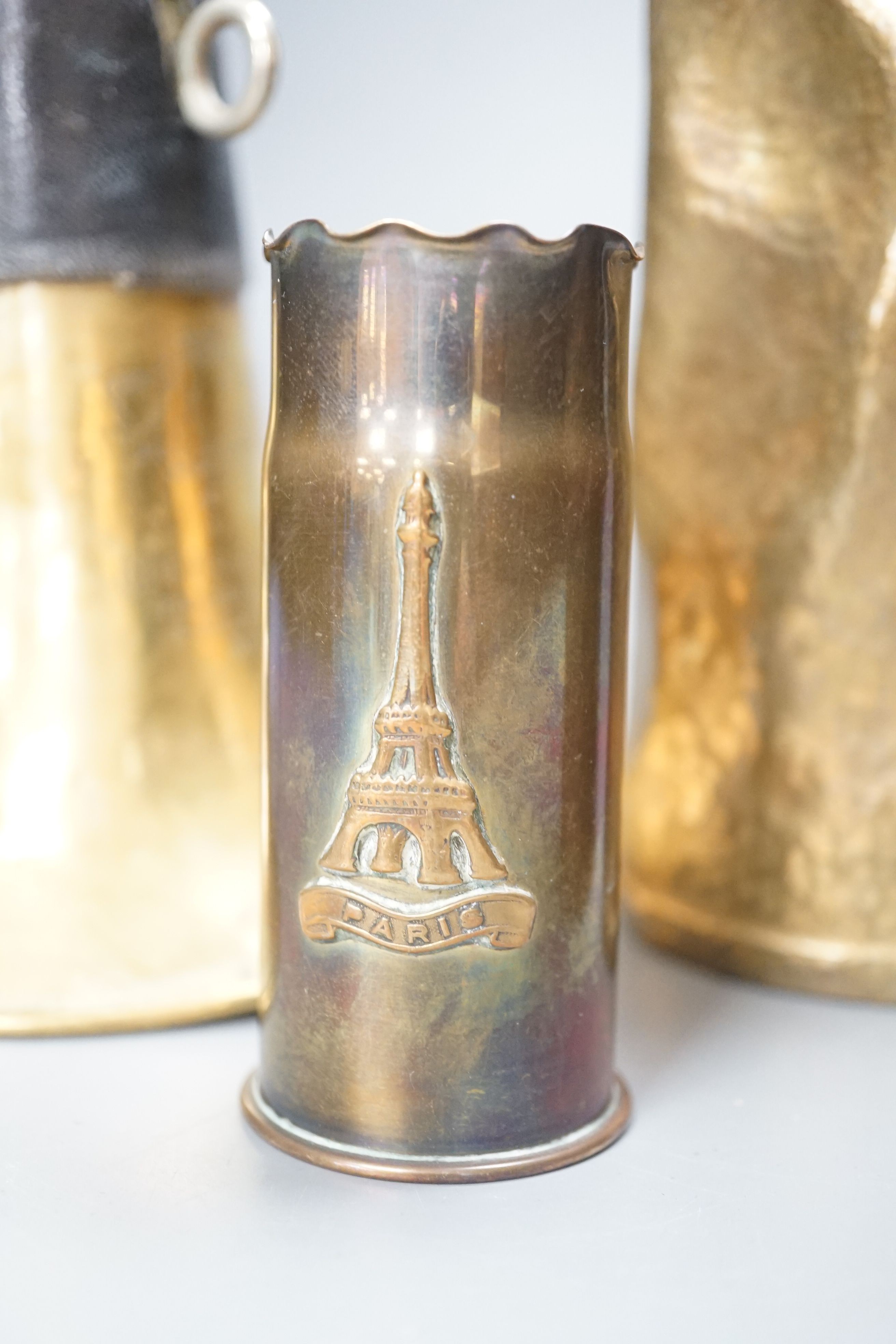 Three WWI brass trench art shell cases and a Couesnon & Cie brass bugle